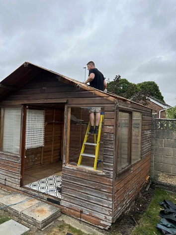 FixWell tradesman carrying out an emergency repair on a shed roof