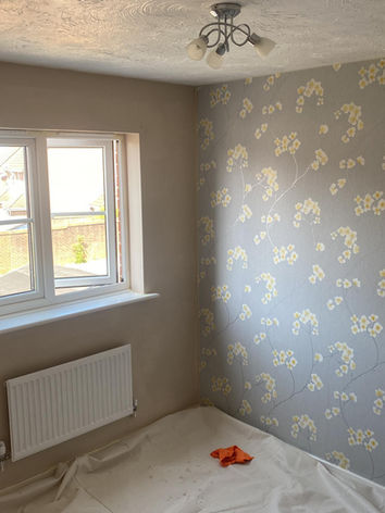 Wallpaper being applied during a decorating job in Wiltshire